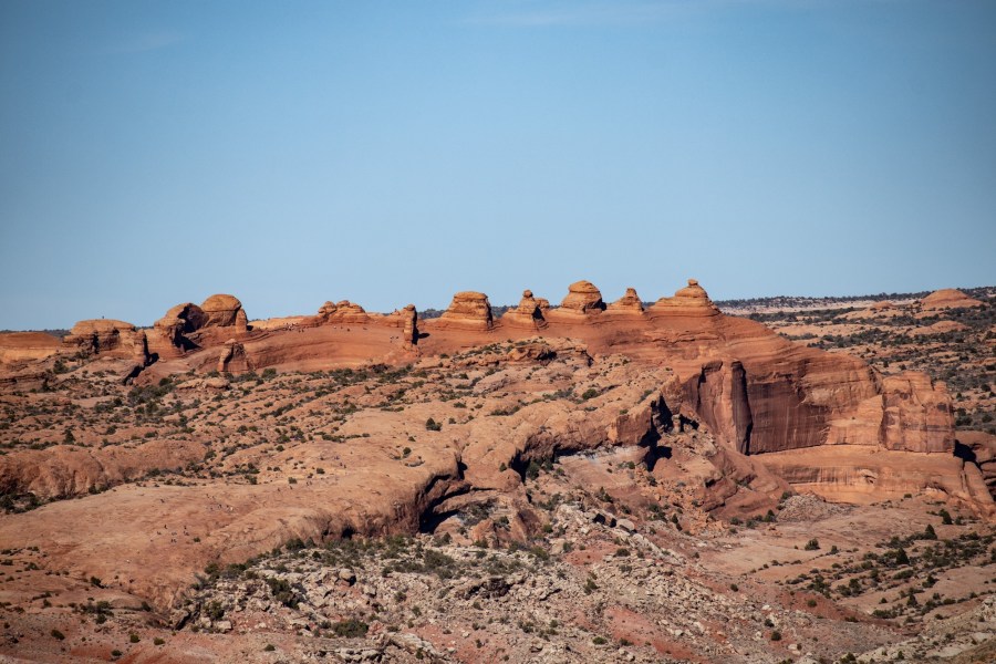This is a unique view of the famous Delicate Arch from a distance. It appears as the thin fin of rock just left of center here.