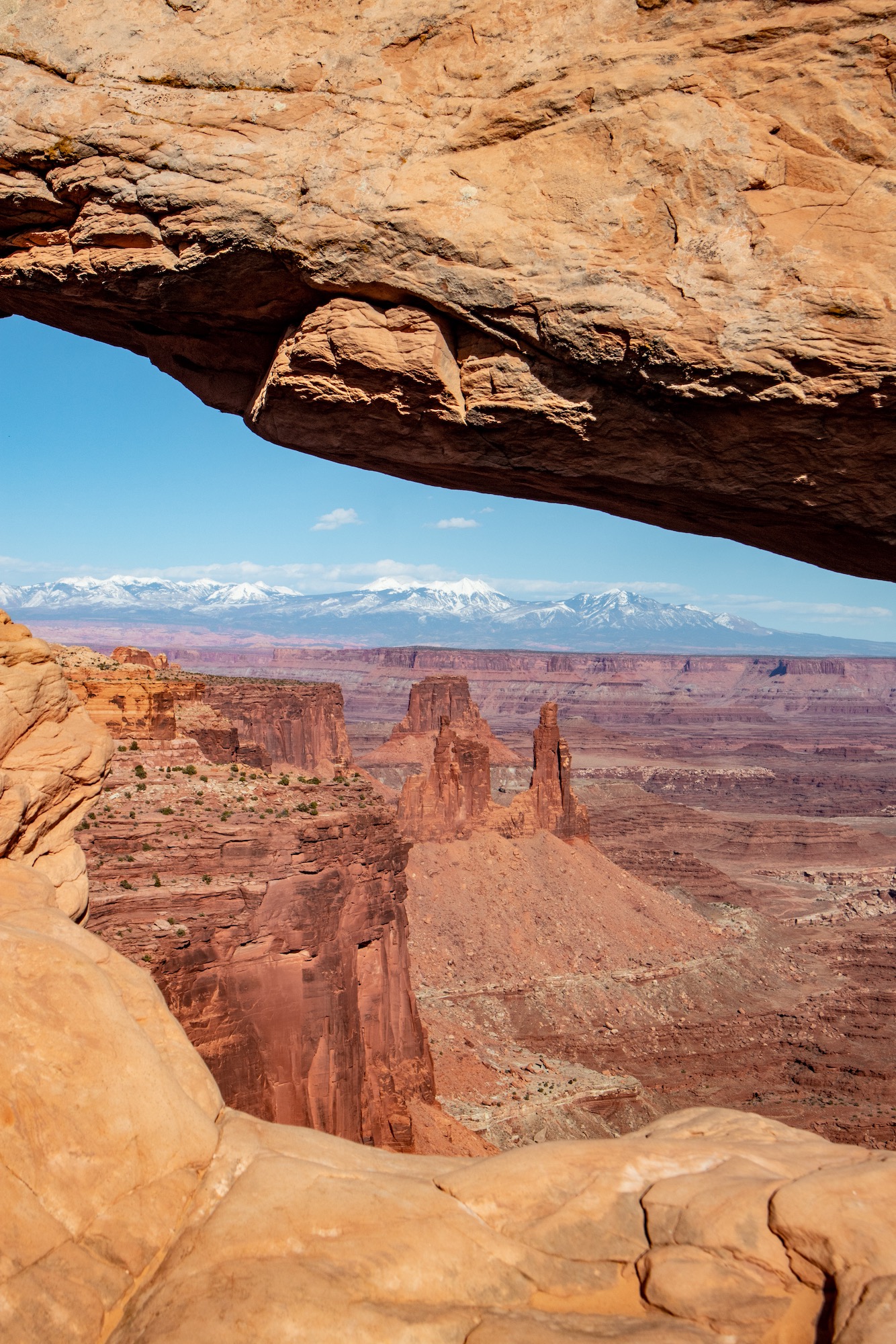 Looking through Mesa Arch toward Washerwoman Arch and Airport Tower.