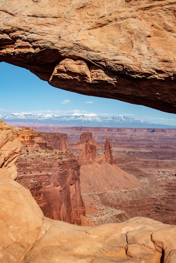 Looking through Mesa Arch toward Washerwoman Arch and Airport Tower.
