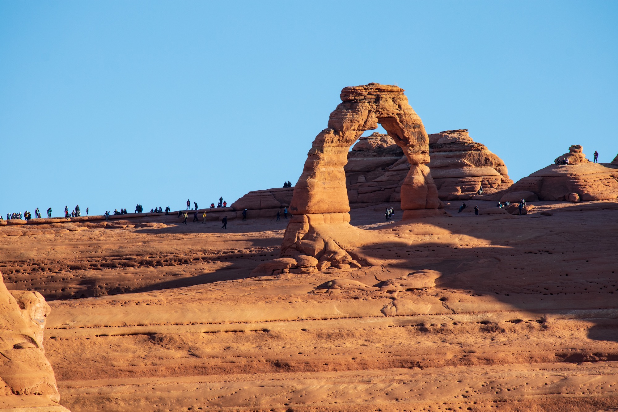 Delicate Arch viewed from the lower viewpoint. Notice the large crowd gathering already.